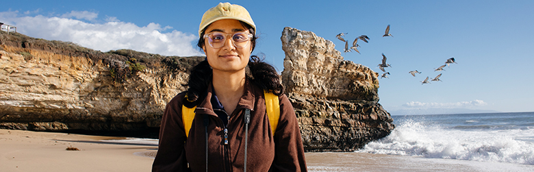 UCSC student on beach conducting research