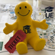 photo of yellow stress toy and a u e glass mug